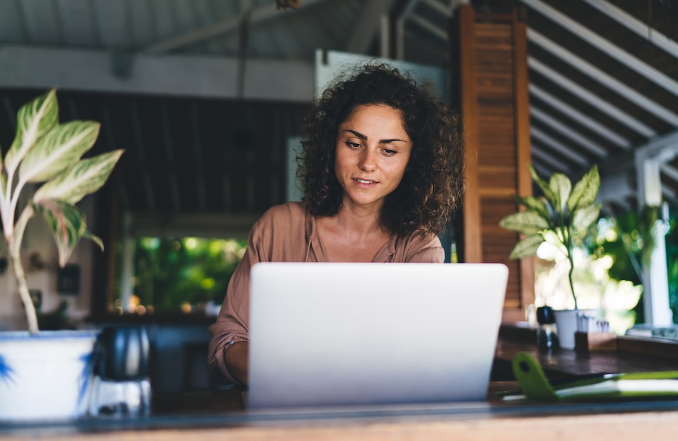 Millennial female blogger using laptop application for communicate with web followers in social media networks, skilled Caucasian woman connecting to 4g wireless internet on modern netbook computer